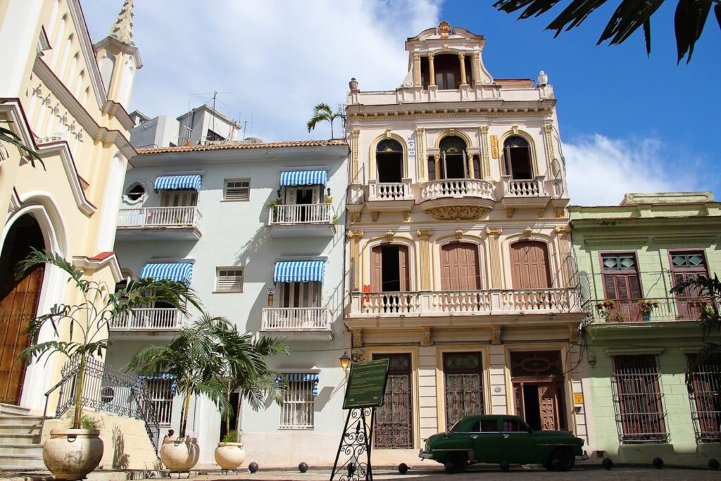 Façades coloniales colorées et voiture américaine ancienne garée dans une rue de La Havane, Cuba