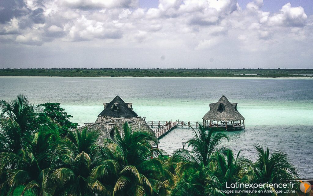 Palapas au toit de chaume et ponton sur le lagon turquoise de Bacalar, Mexique