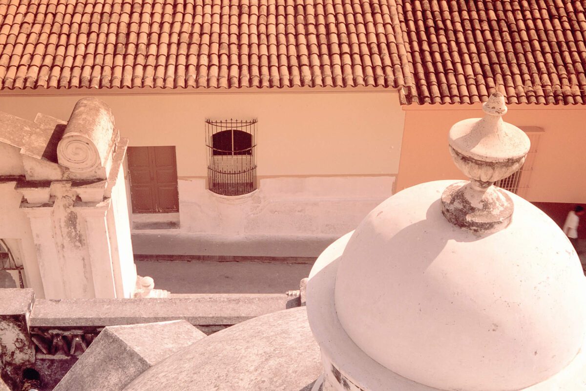 Vue rapprochée d'un dôme blanc et de toits en tuiles d'une église coloniale au Salvador